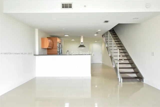 a view of a living room with kitchen