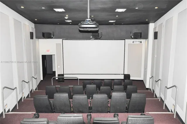 a living room with furniture a refrigerator and kitchen view
