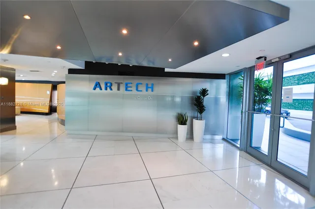 a lobby with entryway and a potted plant