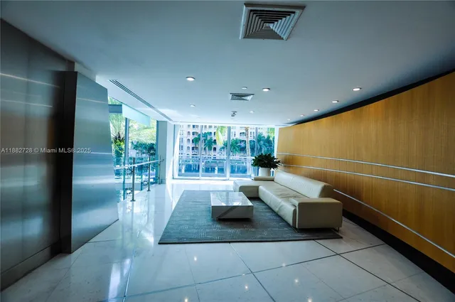 a lobby with furniture and outdoor view
