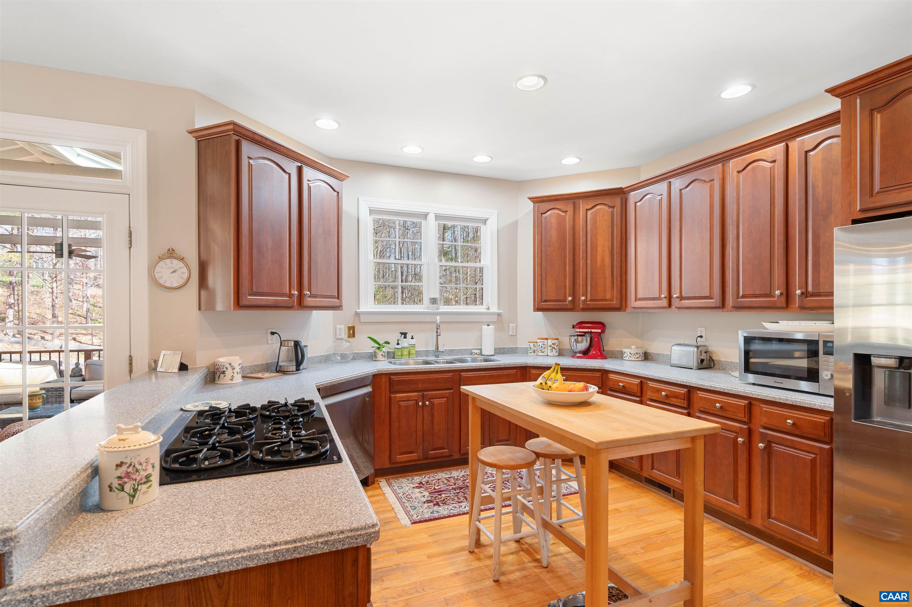 891 Old Ballard Road Charlottesville, VA 22901 - Photo 13 of 49 a kitchen with a sink a stove a refrigerator cabinets and dining table