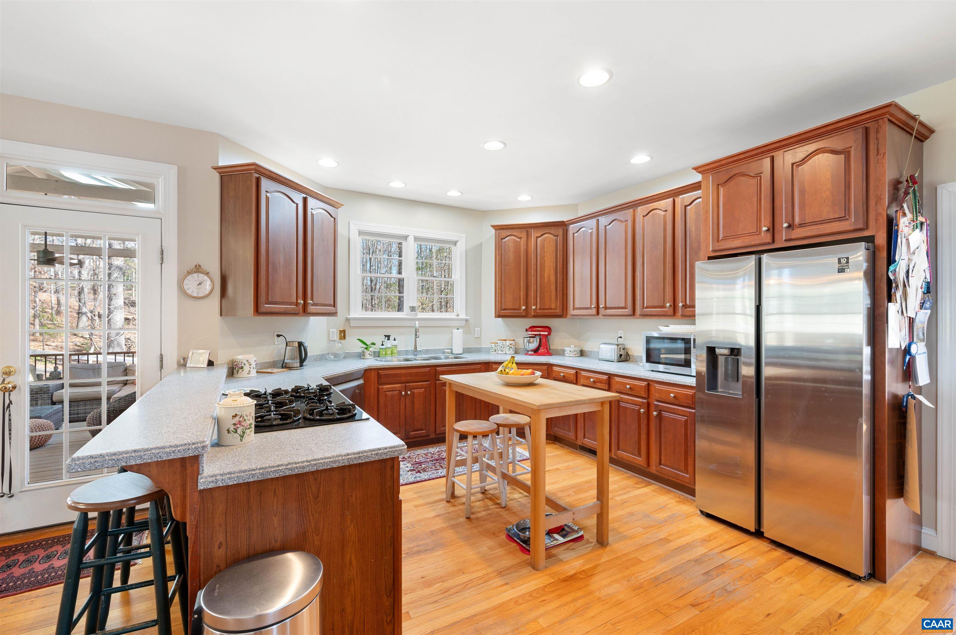 891 Old Ballard Road Charlottesville, VA 22901 - Photo 10 of 49 a kitchen with stainless steel appliances granite countertop a stove a sink a refrigerator cabinets and dining table