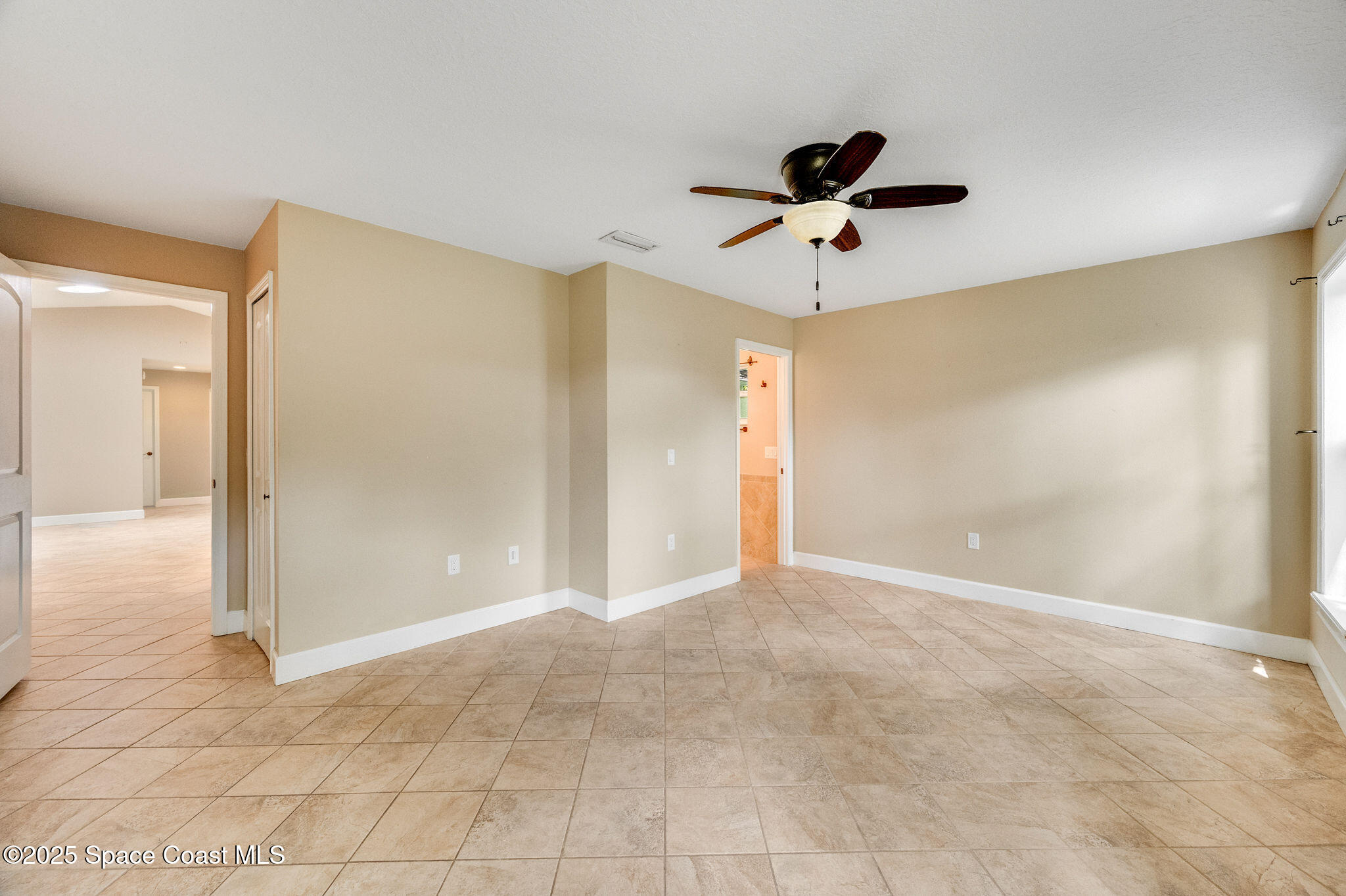 7081 Bayfront Road Cocoa, FL 32927 - Photo 11 of 45 a view of an empty room with a ceiling fan