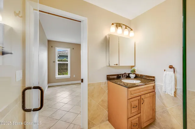 a bathroom with a sink vanity and a mirror