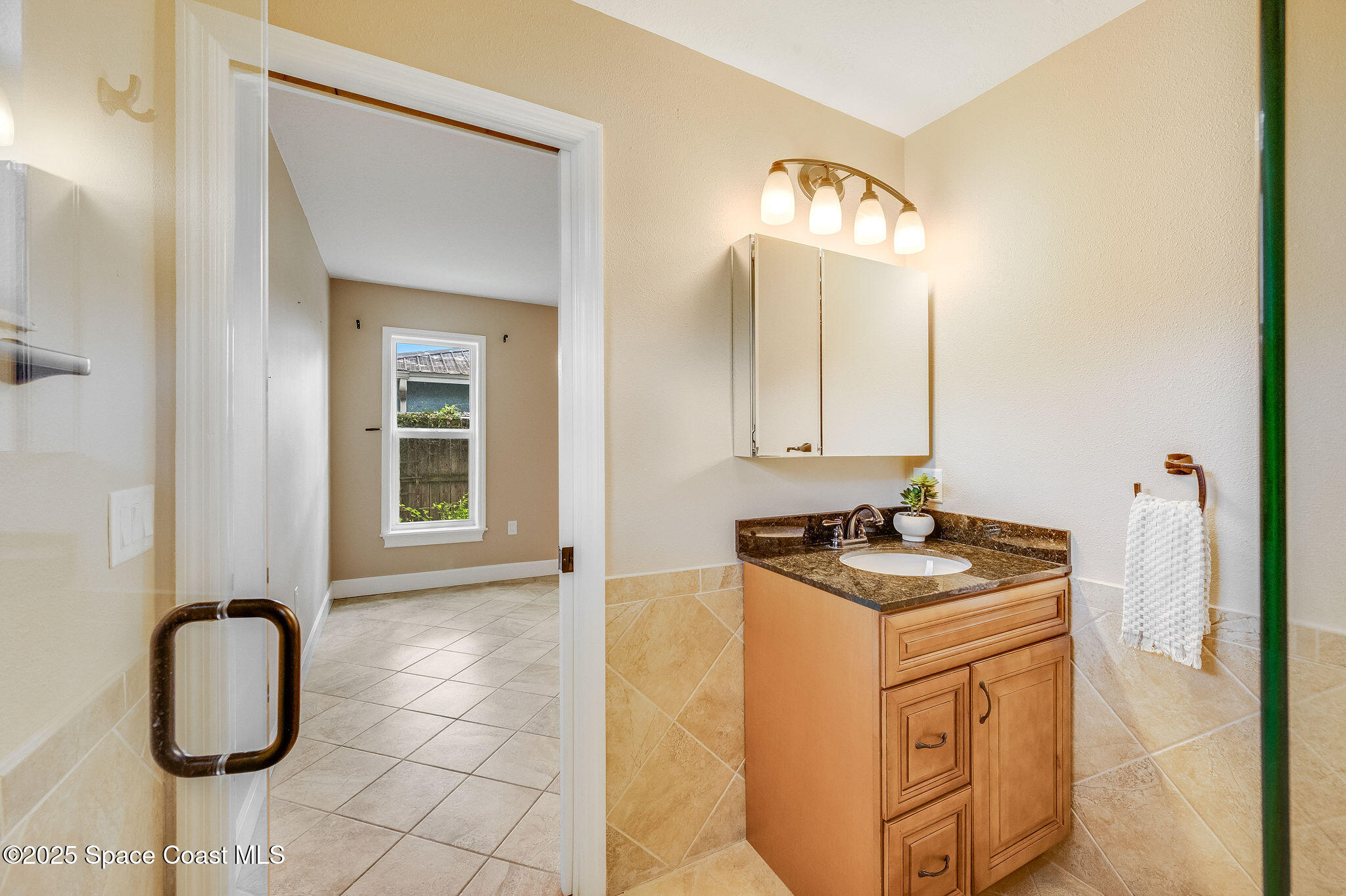7081 Bayfront Road Cocoa, FL 32927 - Photo 14 of 45 a bathroom with a sink vanity and a mirror