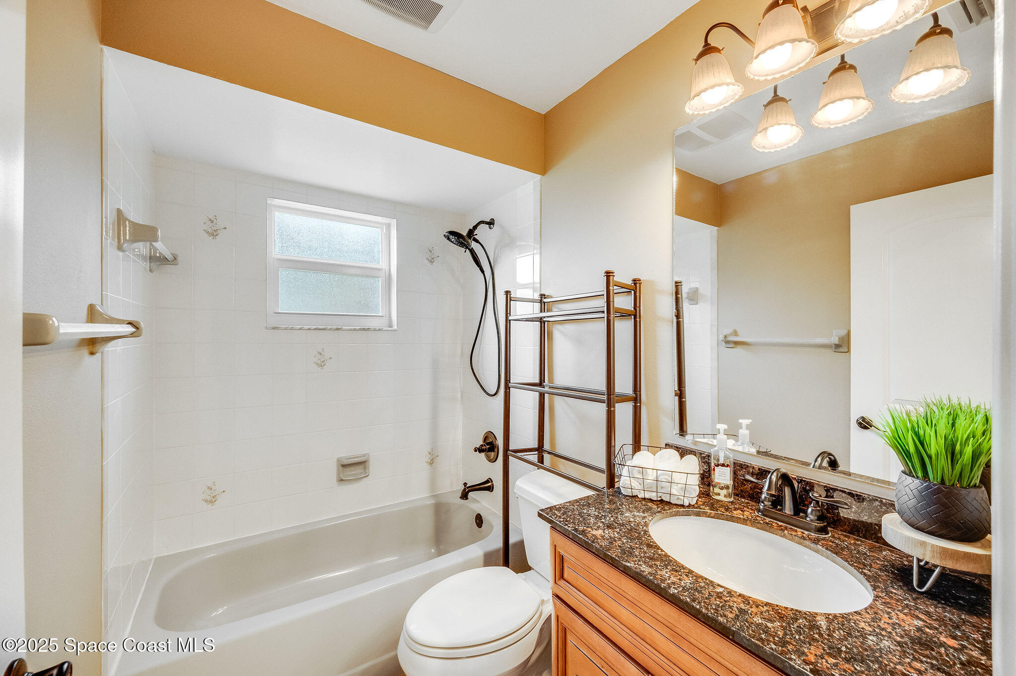 7081 Bayfront Road Cocoa, FL 32927 - Photo 18 of 45 a bathroom with a granite countertop sink mirror toilet and bathtub