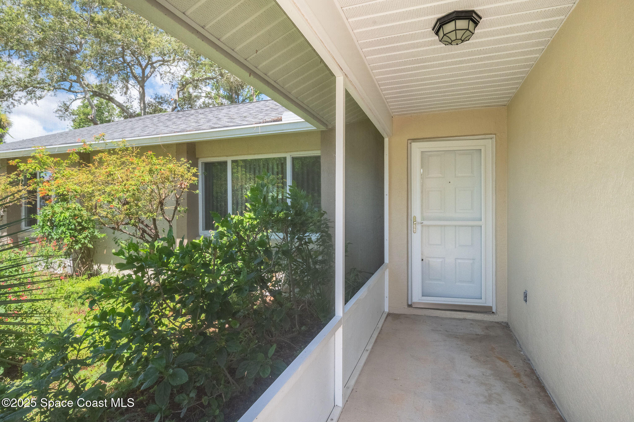 7081 Bayfront Road Cocoa, FL 32927 - Photo 31 of 45 a view of a room with a large window and potted plants