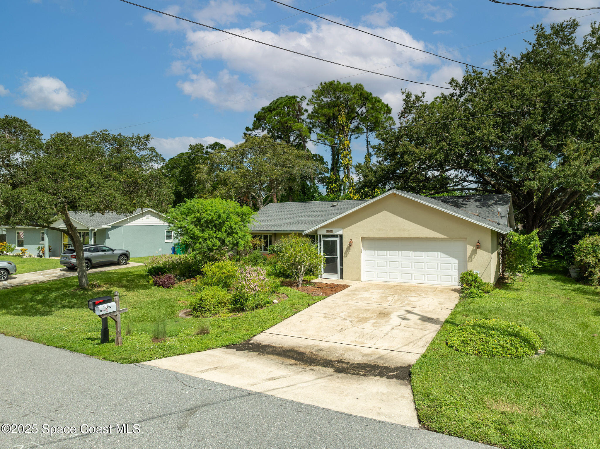 7081 Bayfront Road Cocoa, FL 32927 - Photo 39 of 45 a front view of a house with a yard and garage