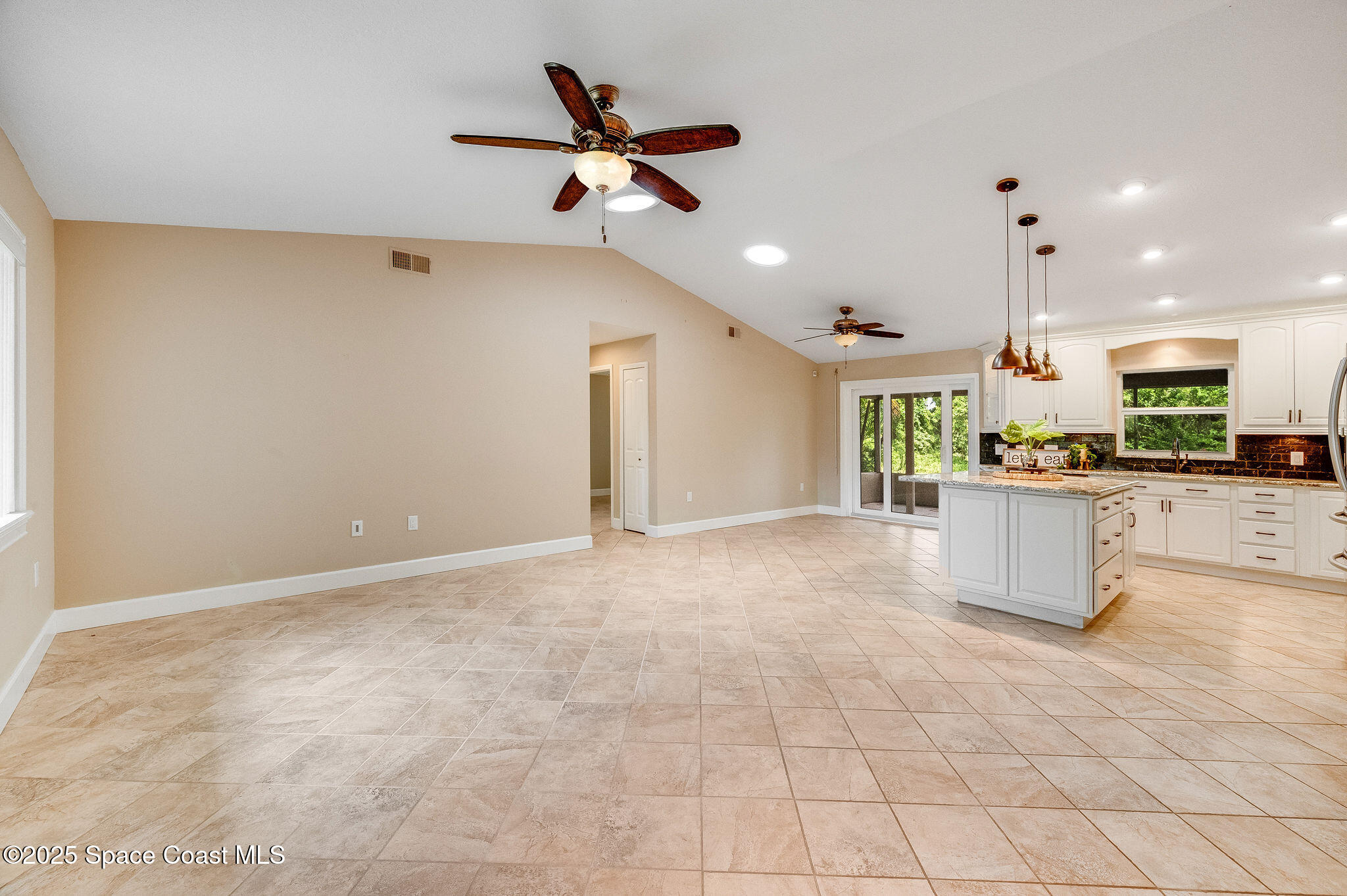 7081 Bayfront Road Cocoa, FL 32927 - Photo 8 of 45 a kitchen with kitchen island white cabinets and stainless steel appliances