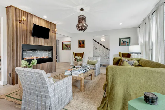 a living room with furniture a fireplace and a flat screen tv