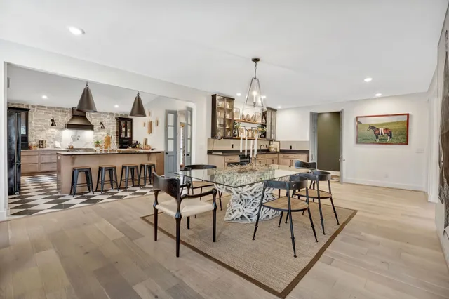 a view of kitchen with granite countertop a sink and a window