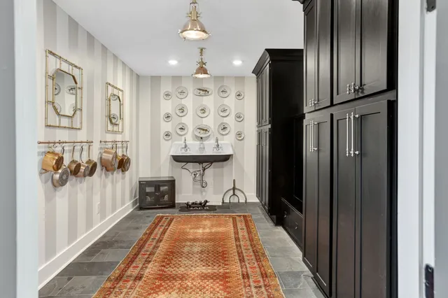 a bathroom with a tub sink and mirror
