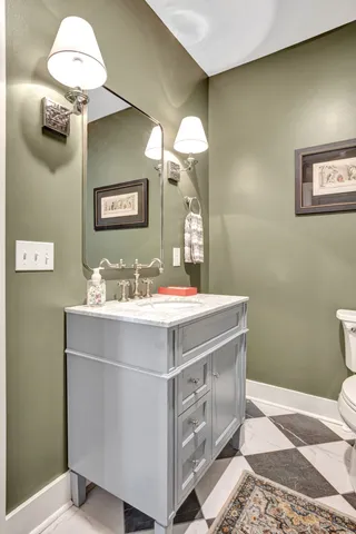 a view of a dining room with furniture a chandelier and wooden floor