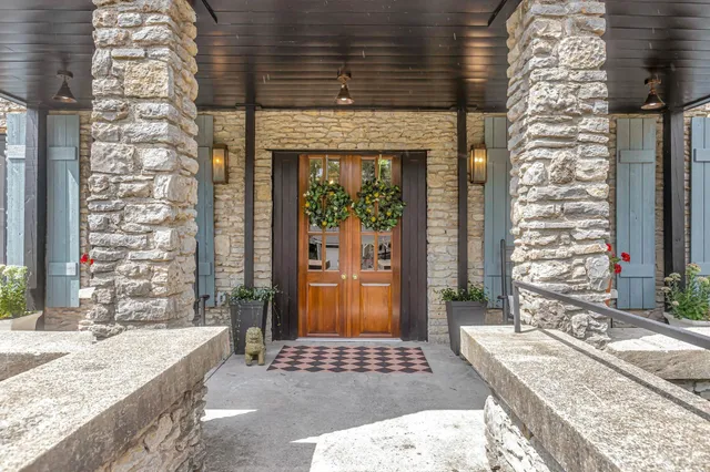 a bathroom with granite countertop shower and a sink