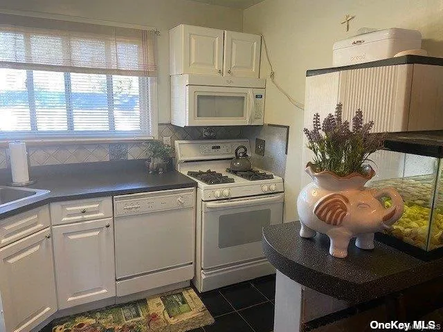 a kitchen with a white cabinets and stove