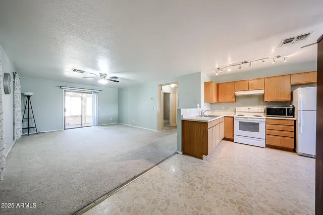 a large kitchen with cabinets and stainless steel appliances