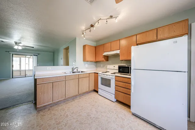 a kitchen with cabinets stainless steel appliances and a window