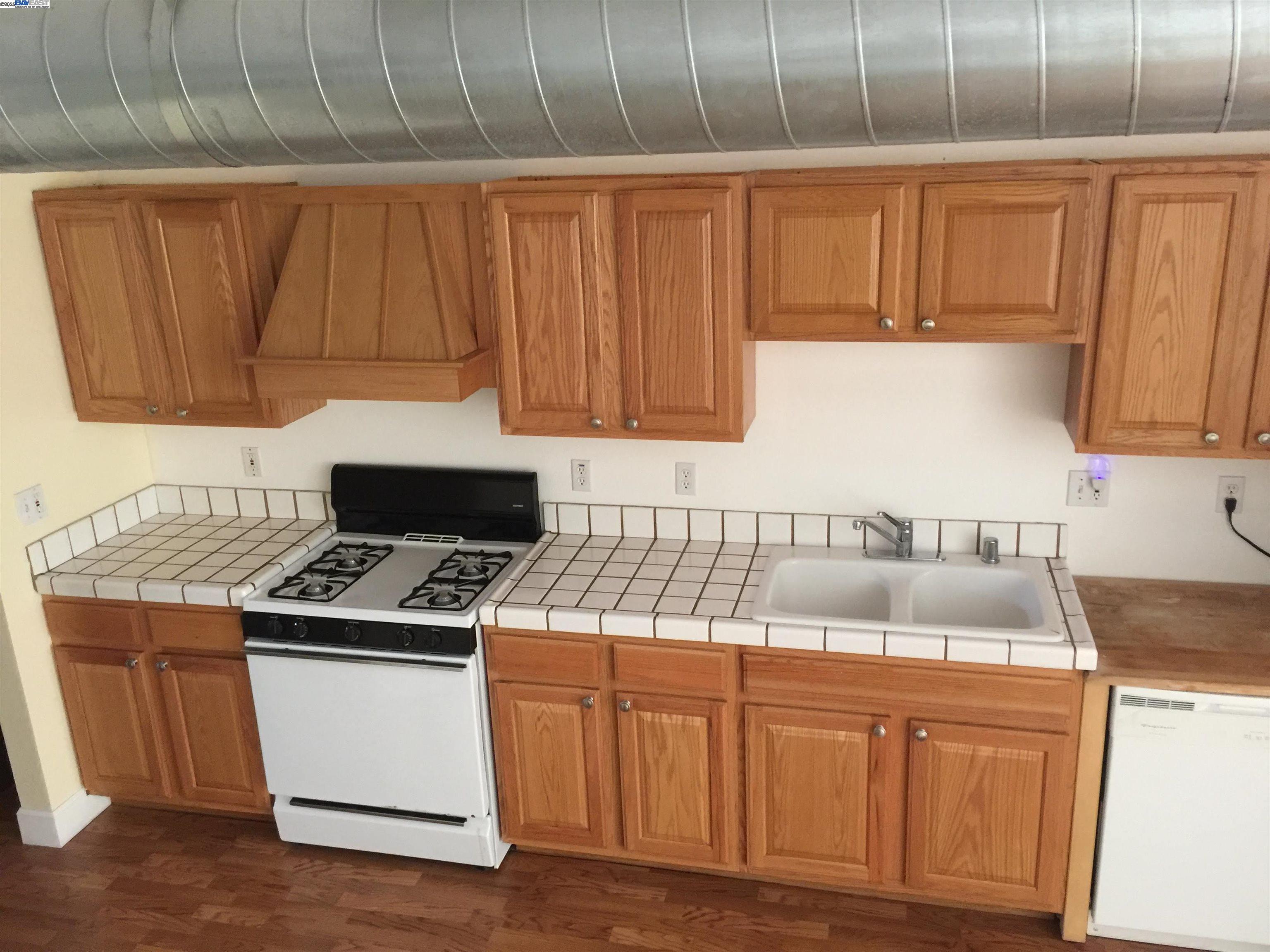2622 Kingsland Avenue Oakland, CA 94619 - Photo 11 of 29 a kitchen with granite countertop a sink stove and cabinets