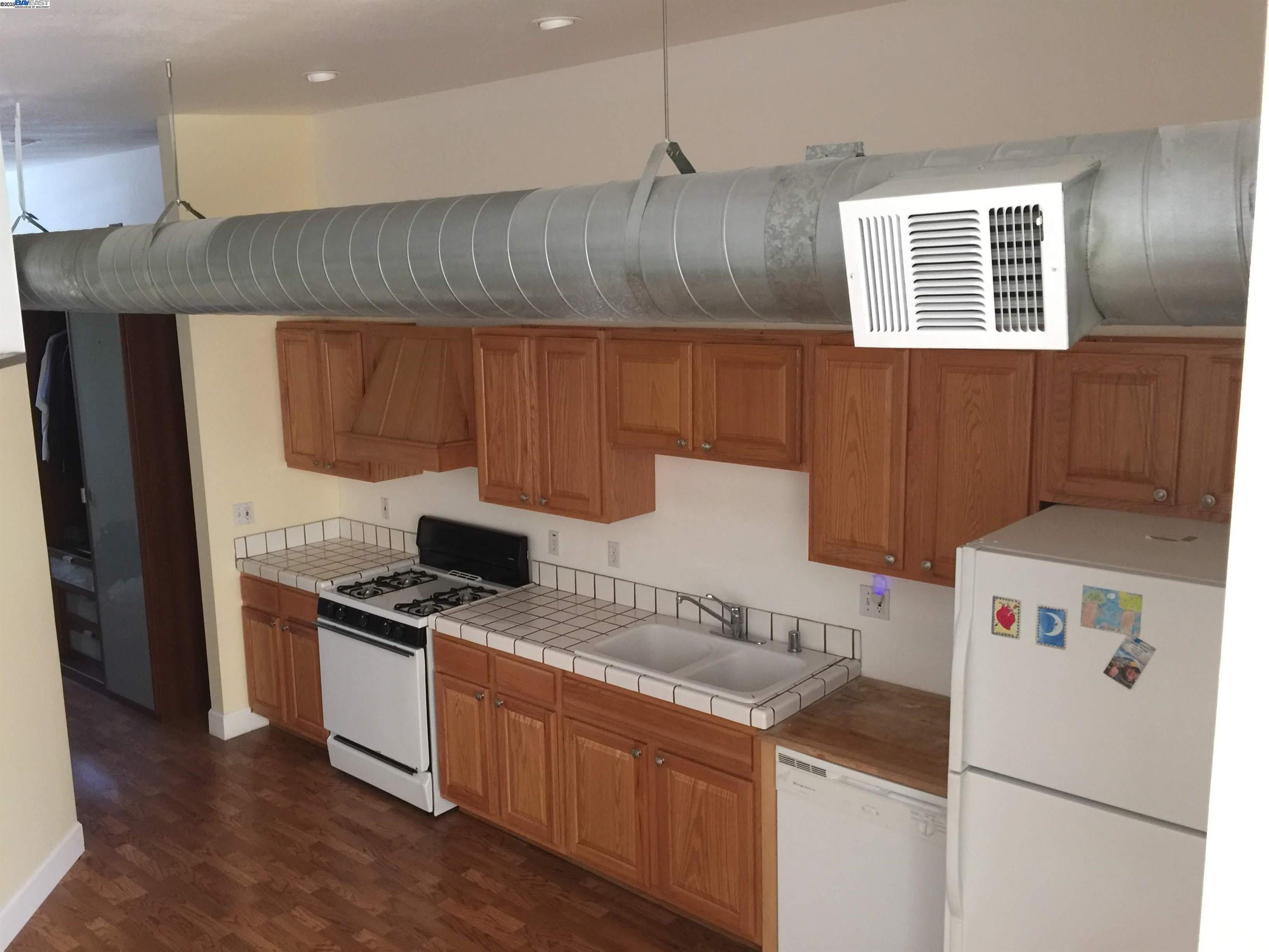 2622 Kingsland Avenue Oakland, CA 94619 - Photo 12 of 29 a kitchen with a stove a refrigerator and a sink