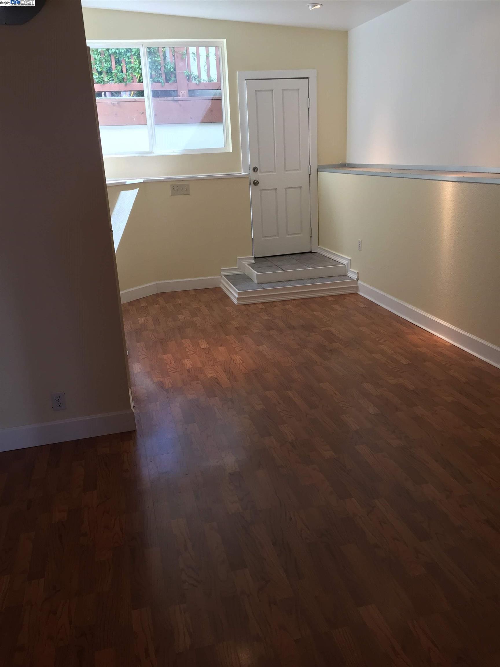 2622 Kingsland Avenue Oakland, CA 94619 - Photo 13 of 29 an empty room with wooden floor and windows