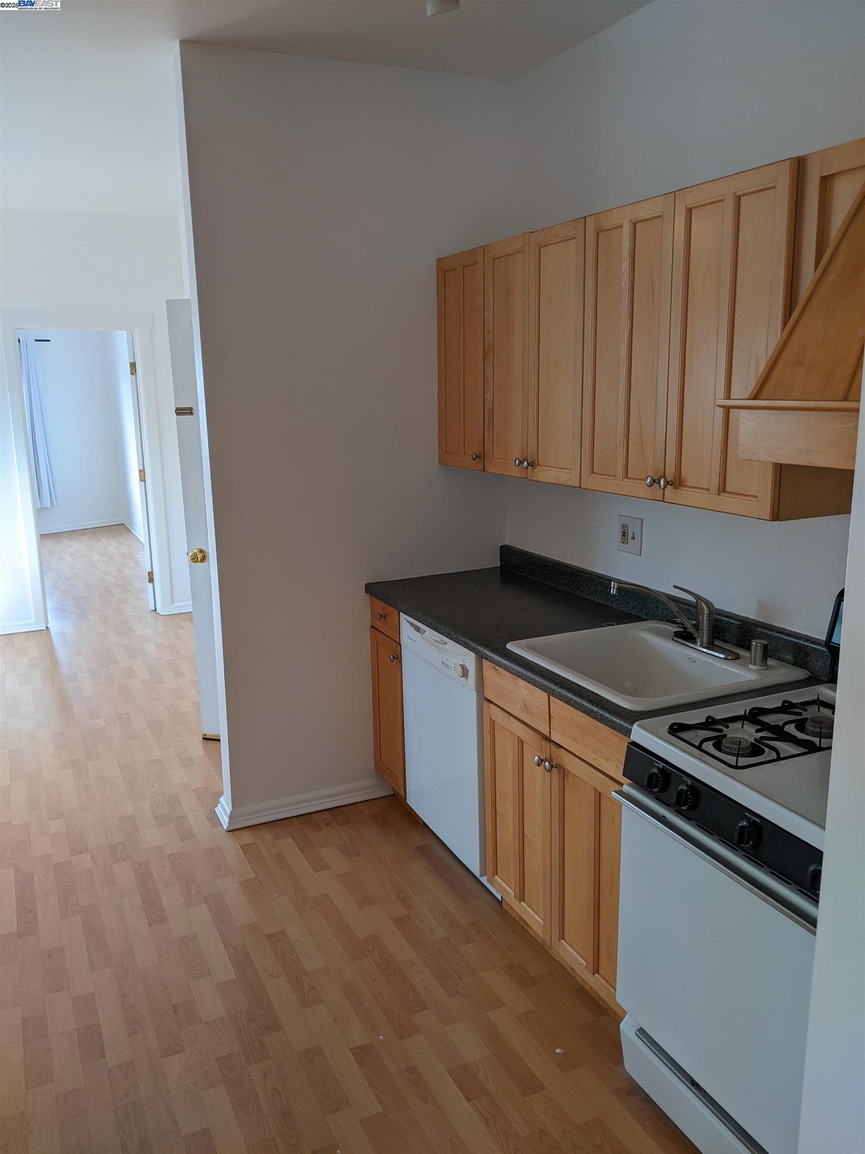 2622 Kingsland Avenue Oakland, CA 94619 - Photo 16 of 29 a kitchen with granite countertop a stove and a refrigerator