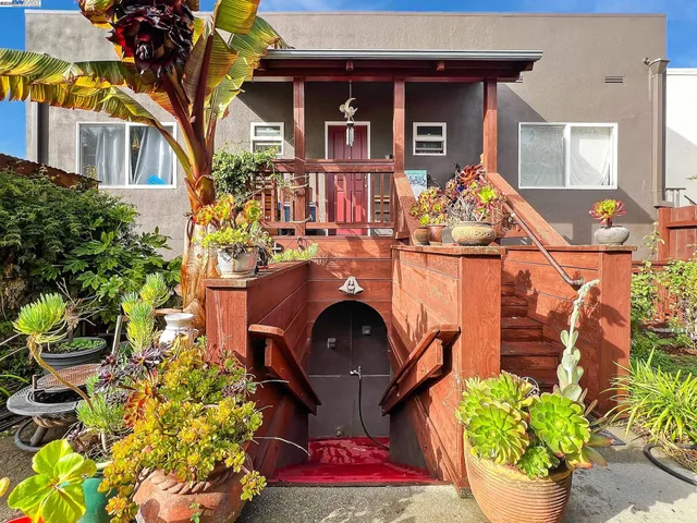 a front view of a house with outdoor seating