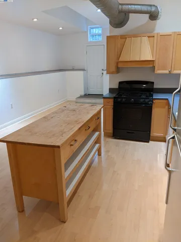 a kitchen with granite countertop a sink a stove and a refrigerator