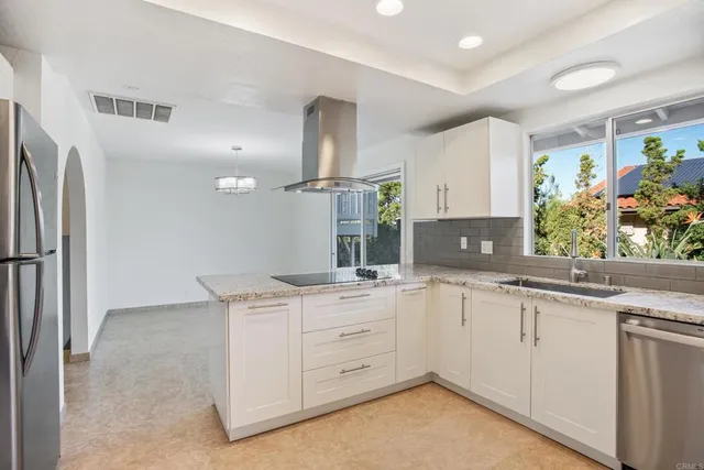a kitchen with a sink stove and refrigerator