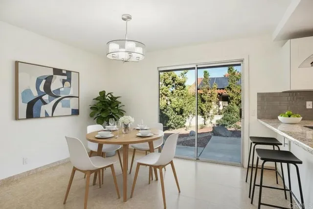 a dining room with furniture and window