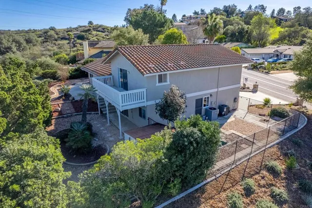an aerial view of house with yard and mountain view in back