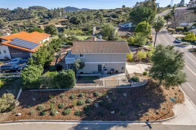 an aerial view of multiple houses with a yard