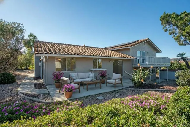 a front view of a house with sitting area