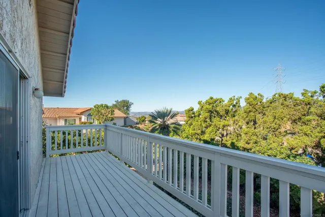 a view of a balcony with wooden fence