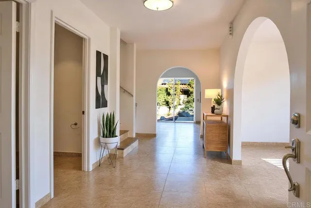 a view of a livingroom with furniture and an entryway