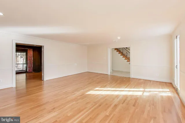 a view of walk in closet with wooden floor and windows