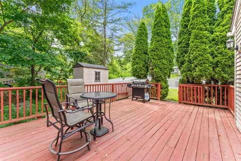 a view of a deck with table and chairs and wooden floor