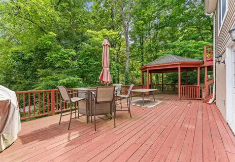 a view of a deck with furniture and wooden floor