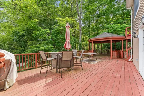 a view of a deck with furniture and a backyard