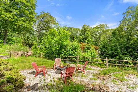 a backyard of a house with table and chairs