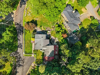 an aerial view of a house with a yard