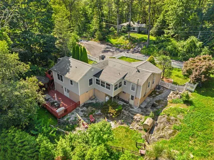 an aerial view of a house with a yard