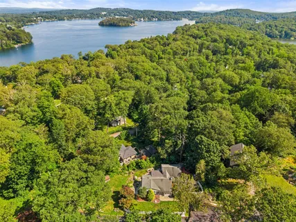 an aerial view of a houses with a lake view