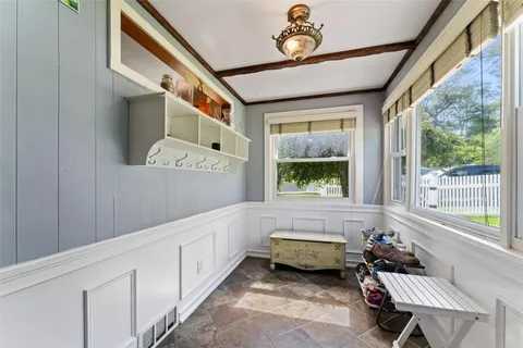 a bathroom with a tub sink and a large mirror