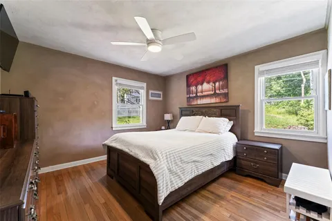 a bedroom with a large bed a chandelier and a window