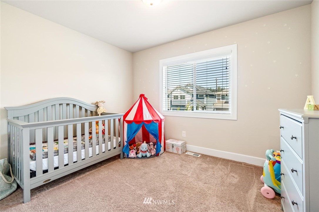 3919 176th Street Southeast Bothell, WA 98012 - Photo 22 of 31 a bedroom with furniture a baby crib and a window