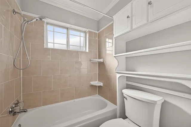 a bathroom with a shower a toilet and sink