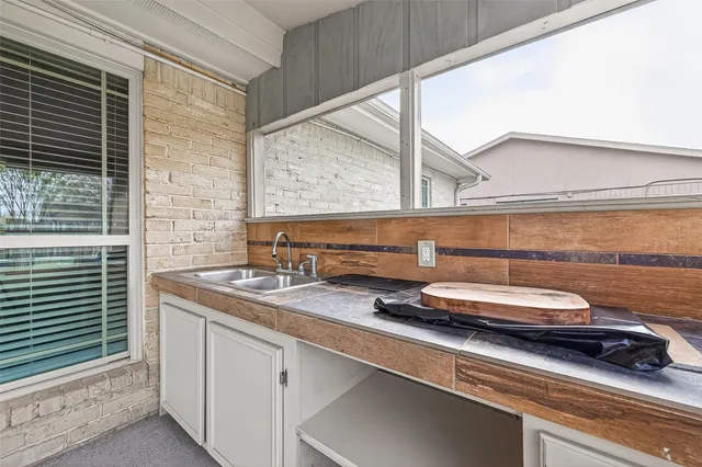 a view of a house with a yard and porch
