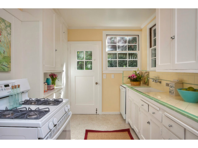 406 Edgewood Road San Mateo, CA 94402 - Photo 11 of 24 a kitchen with a stove and white cabinets