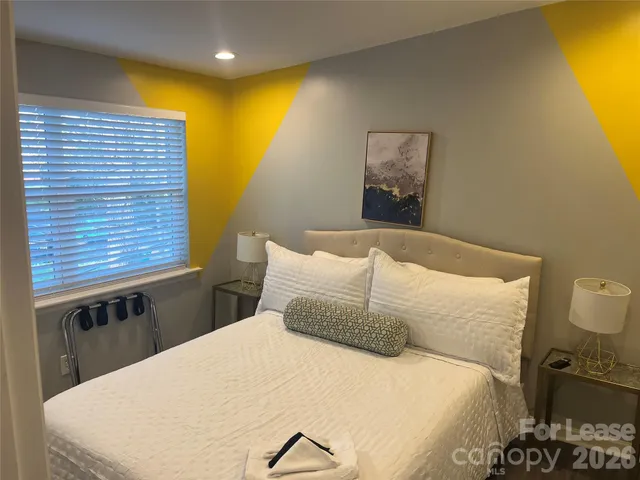 a bedroom with a bed and chair