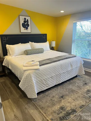 a bedroom with a bed and window